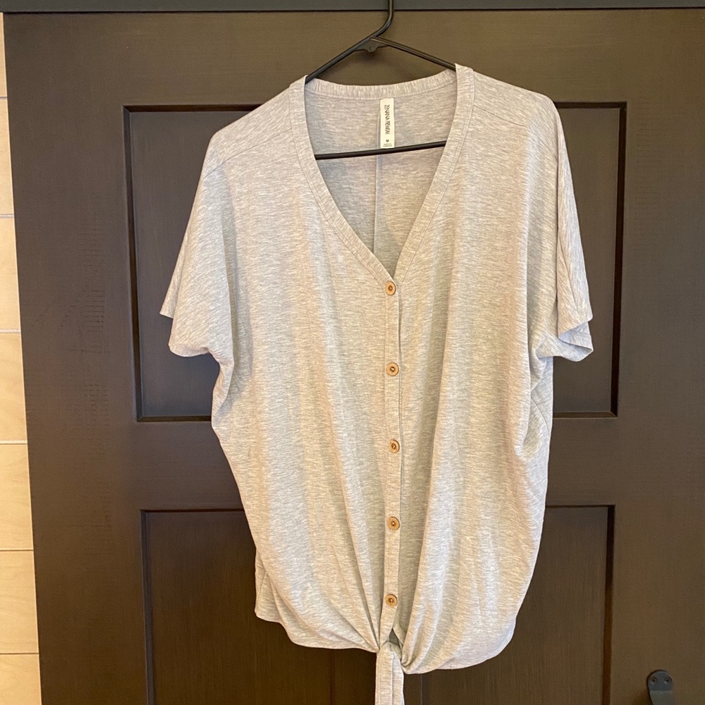 Button front with tie on bottom tee.